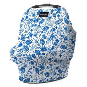 The Milk Snob Cover Disneys Stitch is multifunctional with a white background, featuring blue jungle-themed illustrations of monkeys, leaves, and cocoa pods. It doubles as a nursing cover and includes a small black label displaying the brand name Milk Snob at the top.