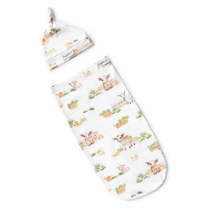 Snuggle Hunnys Organic Swaddle & Beanie Set, Farm theme, features charming sheep, cows & carrots—ideal for birth announcement photos.