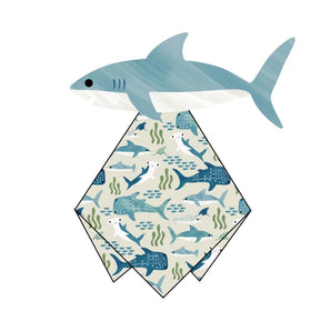 A shark illustration holds a patterned napkin in its mouth. The Bamboo Lovey by Emerson and Friends, ideal as a nursery gift, showcases marine animals like sharks and fish on a light green seaweed-themed background.