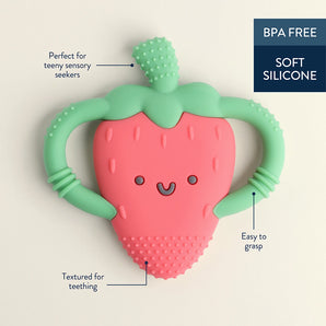 The Itzy Ritzy Chew Crew Strawberry teether, shaped like a smiling strawberry, is crafted from soft, BPA-free silicone. It features green handles and textured surfaces for teething relief and gum soothing, ideal for sensory seekers and easy to grasp.