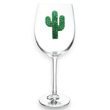 The Queen Jewels Stemmed Wine Glass, Green Cactus is a clear glass featuring a green cactus design with glittery stones, packaged in a decorative gift box. These jeweled glasses create a stunning centerpiece ideal for any occasion.