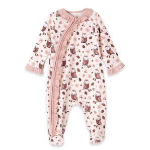 The Tesa Babe Romper, Hootie, is an ivory baby onesie with an owl and leaf print. It features brown and pink patterns, a soft pink ruffle trim along the zipper, matching ruffles at the long sleeve cuffs, eco-friendly fabric, and enclosed feet for cozy comfort.