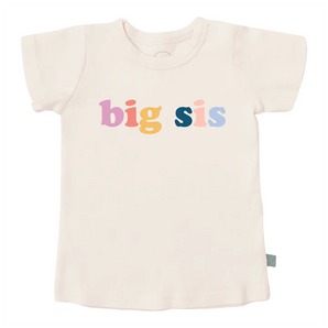 The Finn and Emma Organic Tee, Big Sis is cream-colored, featuring a playful big sis print, made with organic cotton and eco-friendly dyes.