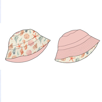 The left reversible bucket hat, featuring the Sandy Seashells print with shells and stars from Emerson and Friends, contrasts beautifully with the Bubblegum Pink counterpart on the right. Both share a similar shape and style, set against a plain white background.