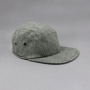 Storied Hats Lil Hat, Tuxedo: Tweed gray baseball cap with flat brim for sun protection, shown side/front on gray background.