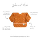 Part of Bumkins Desert Boho, the Sleeved Bib: Grounded has arrows, elastic cuffs, an adjustable neck, and a pocket. For ages 6-24 months.