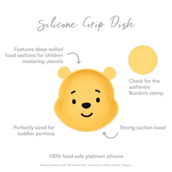 The charming yellow Silicone Grip Dish: Winnie The Pooh by Bumkins is bear-shaped and ideal for toddlers, with deep-walled sections for convenience. It features a strong suction base, an authenticity stamp, and is crafted from 100% food-safe silicone for secure mealtimes.