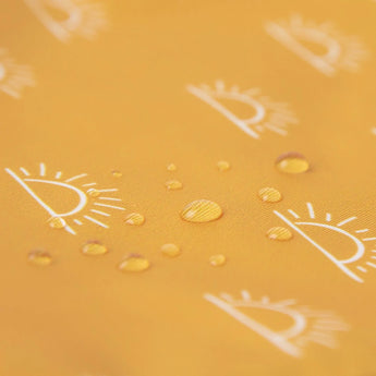 Water droplets on the yellow Sunshine fabric with white eye designs from Bumkins Reusable Snack Bag, Large 2-Pack.