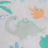 Illustration of a smiling green dinosaur on Bumkins waterproof Sleeved Bib with orange and blue leaf accents.