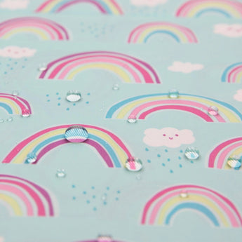 Bumkins Wet/Dry Bag: Rainbows features a cute pattern of rainbows, smiling clouds, and water droplets on light blue waterproof fabric.