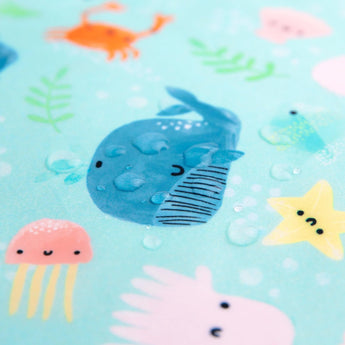 The Bumkins Wet Bag: Ocean Life features a light blue waterproof fabric with illustrated sea creatures like a blue whale and jellyfish.