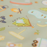 Water droplets on Bumkins SuperBib®: Camp Gear, featuring camping-themed icons of a tent, fire, footprints, and a sign.