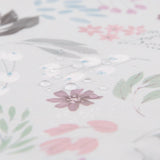 Water drops on Bumkins Wet Bag: Floral, featuring pastel pink, purple & green flowers and leaves on waterproof fabric.