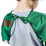 Child in Bumkins Sleeved Bib: Zelda™, waterproof fabric, open back over gray shirt, facing away.