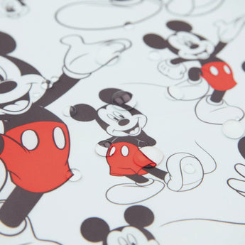 Bumkins Junior Bib: Mickey Mouse Classic features waterproof fabric with black outlined cartoon mice and red shorts.