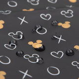 Waterproof fabric featuring gold Minnie Mouse icons with hearts and X, O symbols by Bumkins, ideal for reusable bags.