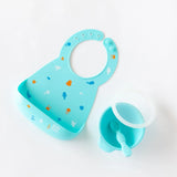 The Silicone First Feeding Set: Blue by Bumkins includes a bib, bowl, and spoon made of food-safe silicone with sea creature designs.