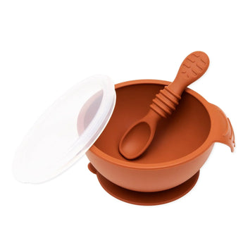 Bumkins Silicone First Feeding Set: Clay, with baby spoon inside the bowl and a transparent lid beside it.