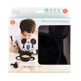 A child enjoys a meal with Bumkins Silicone First Feeding Set: Mickey Mouse Classic Black, crafted from food-safe platinum silicone.