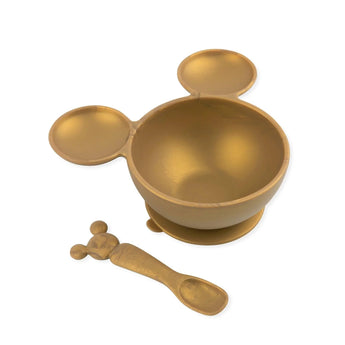 The Silicone First Feeding Set by Bumkins features a Minnie Mouse gold bowl and spoon with iconic round ears.