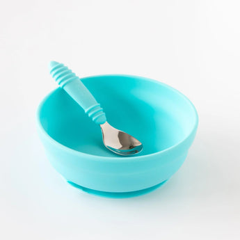 The Bumkins Silicone Grip Bowl in blue, paired with a matching spoon, is ideal for toddlers learning to self-feed.