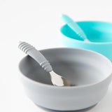 Two Bumkins Silicone Grip Bowls, gray and blue, include spoons with soft ribbed handles, made of food-safe platinum silicone.