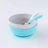 Bumkins Silicone Grip Bowl: Marble. Two stacked bowls in white and blue with a textured silver spoon, ideal for self-feeding toddlers.