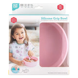 Bumkins pink Silicone Grip Bowl has an interior ridge for stability, a secure suction base, and is shown with a smiling child.