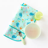 Bumkins Silicone Grip Bowl in Sage comes with a marine-themed bib, a suction bowl, cup, and spoon with a striped handle.