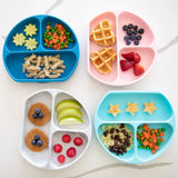 Bumkins Silicone Grip Dish in Blue stylishly holds pasta, waffles, fruit, and veggies on its food-safe surface.