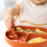 A child enjoys strawberries, omelette, and yogurt on a Bumkins Silicone Grip Dish: Clay with a secure suction base.