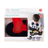 A baby enjoys food from the Bumkins Silicone Grip Dish: Minnie Mouse, featuring a fun design and suction base.