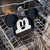 The Bumkins Silicone Grip Dish: Mickey Mouse sits securely in the dishwasher, showcasing its iconic ears and face. Ideal for toddler feeding, it is positioned upright within the metal structure of the rack.