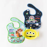 Three colorful baby bibs featuring Buzz & Woody, paired with a Bumkins Silicone Grip Dish: Toy Story Alien, on a white background.