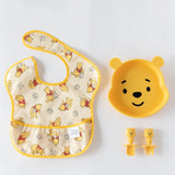 Winnie the Pooh Silicone Grip Dish and baby utensils set by Bumkins on a white background.