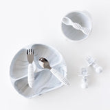 The Bumkins Marble Silicone Grip Dish set includes a suction plate, cup, cutlery, and pacifiers on a white background.