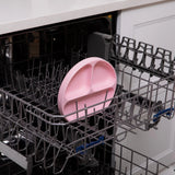 The Bumkins Silicone Grip Dish in pink is perfect for toddler self-feeding and is safe for the dishwashers top rack.