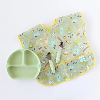 A Bumkins mint Silicone Grip Dish in Sage with camping pattern and included green utensils on a white background for toddler feeding.