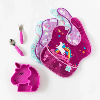 Unicorn-themed assorted baby bibs, Bumkins Silicone Grip Dish Special Edition: Unicorn, and matching pink unicorn-shaped bowl on white.