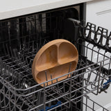 The Bumkins Silicone Grip Dish: Wood Grain is shown sitting in an open dishwasher rack.