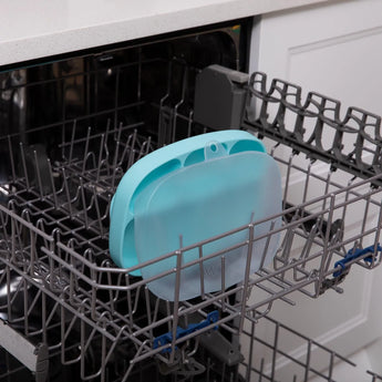 The Bumkins Silicone Grip Dish with Lid is ready for cleaning on the top rack of your dishwasher.