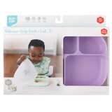 Bumkins Silicone Grip Dish with Lid (5 Section) in Lavender features a vibrant purple dish made from food-safe silicone, ideal for toddler portions. The packaging shows a happy child using the compartmentalized design, suitable for ages 6 months and up.