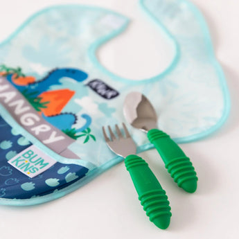 The Bumkins Ultimate Gift Set pairs a blue HANGRY dinosaur bib with Chewtensils, featuring a green-handle fork and spoon.