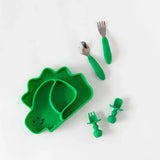 The Bumkins Ultimate Gift Set includes a dinosaur divided plate with Chewtensils, featuring silicone grip and suction cup bases.