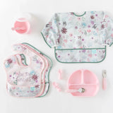 Adorable Bumkins Ultimate Gift Set with floral SuperBibs, a pink Silicone Grip Dish, pink cups, and Chewtensils. Bib: love you bunches.