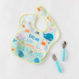 Bumkins Ultimate Gift Set: Ocean Life & Whale Tail features a Colorful SuperBib & blue-handled Silicone Chewtensils on white.