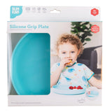 A child holding food beside a vibrant blue Bumkins Silicone Grip Plate with suction base.