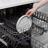 A hand places a Bumkins Silicone Grip Plate: Marble with strong suction into an open dishwasher.