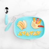 Aqua plate with apple slices, hummus, and cheese triangles on a Bumkins Silicone Grip Tray: Blue. Aqua utensils rest on the marble.