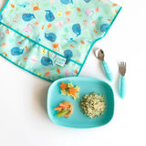 Childrens meal with star and veggie shapes on Bumkins Silicone Grip Tray: Blue; quinoa, colorful bib, and matching cutlery.